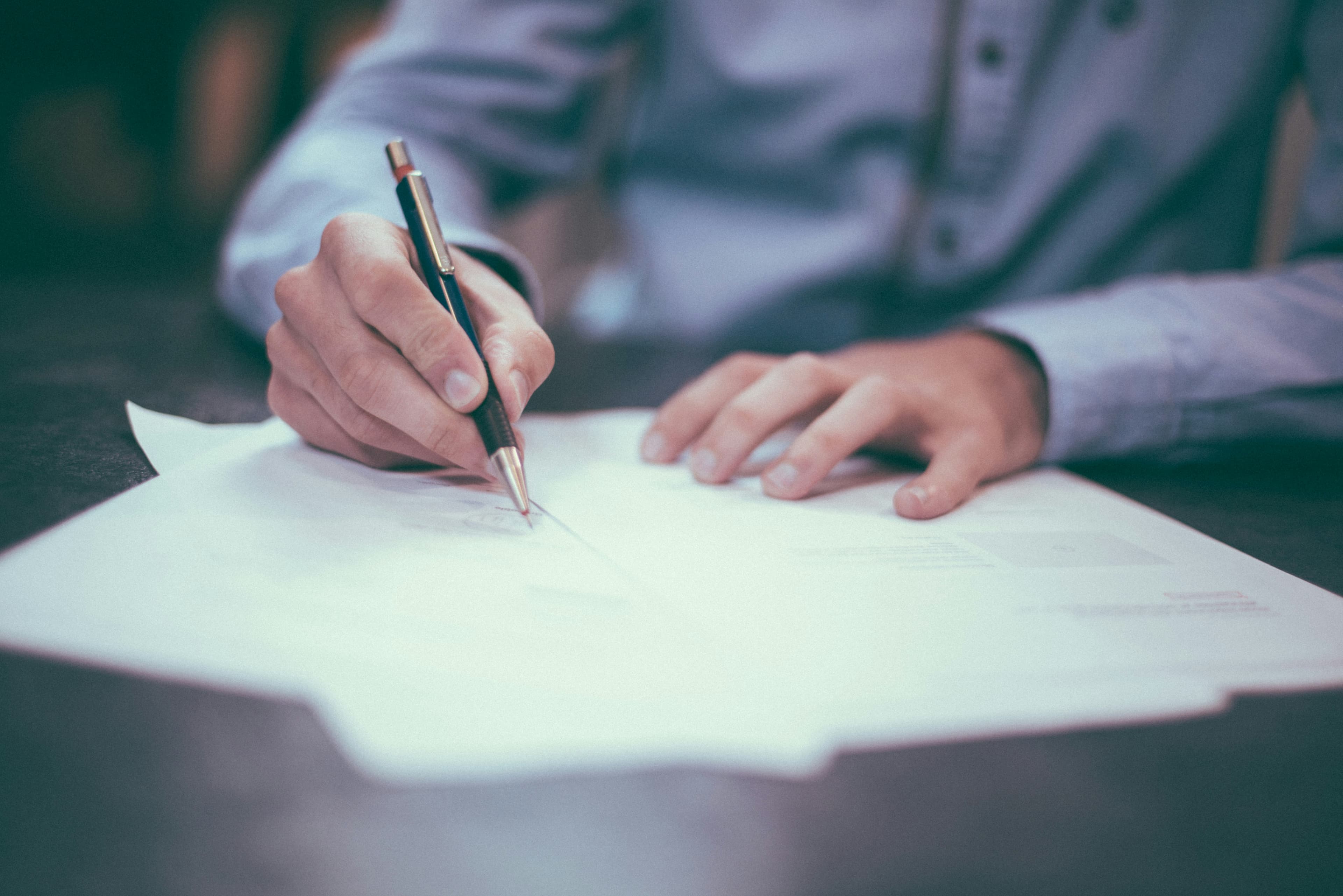 A desk covered with paper notes, maps and planning research — practical answers for construction growth teams.