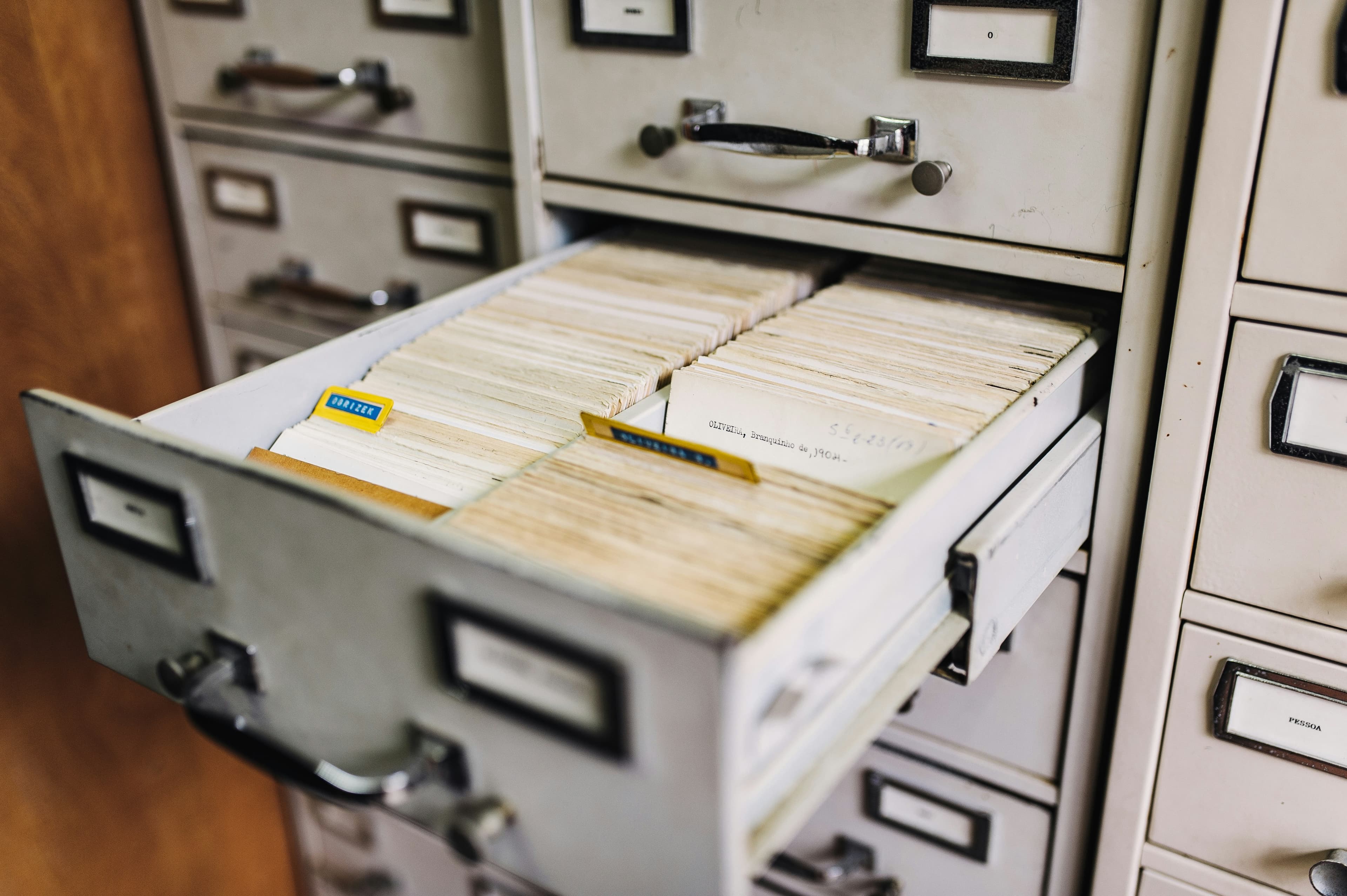 Vintage library card catalogue drawer, an editorial metaphor for applicant enrichment — matching the right person to every planning record.